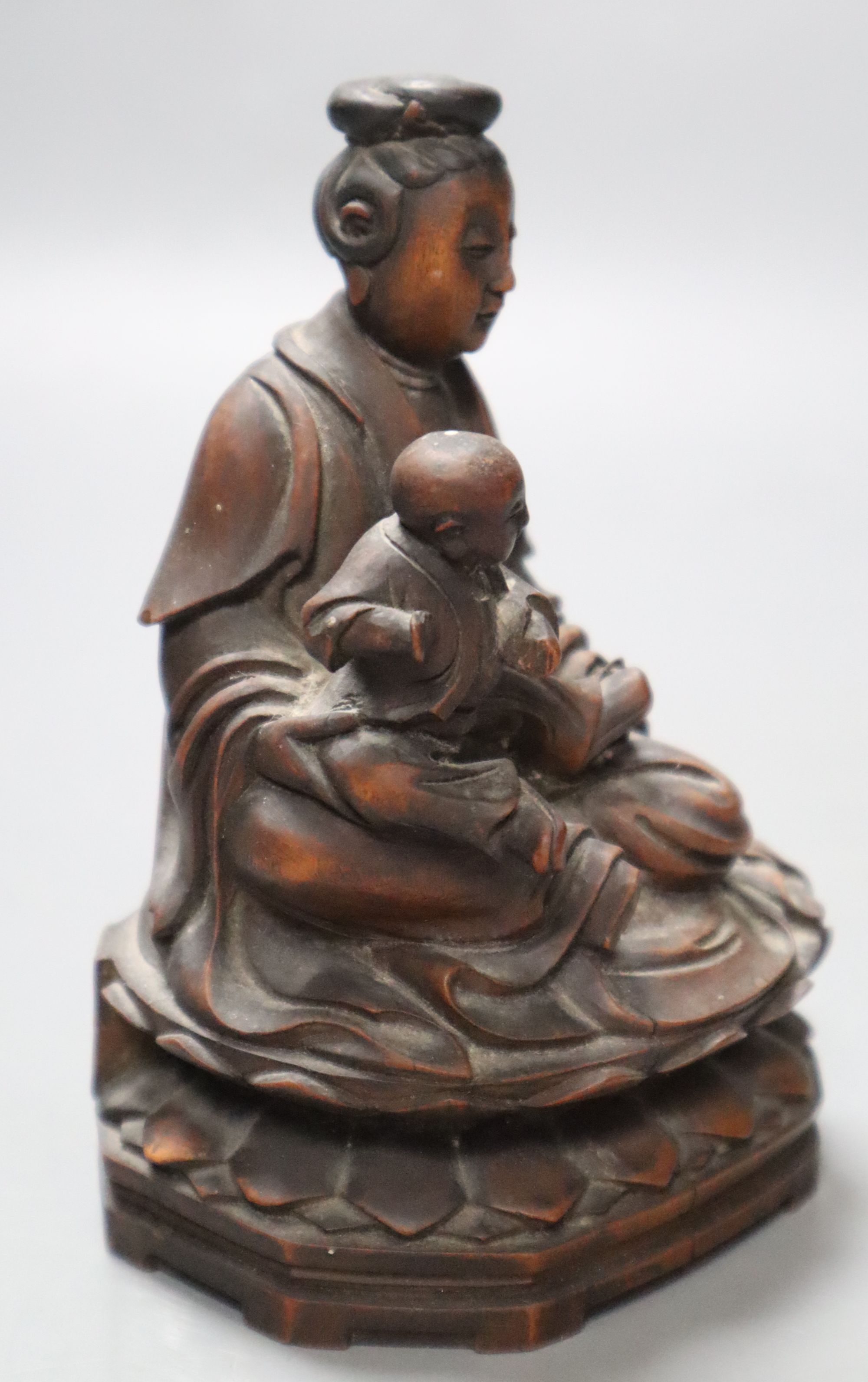 A 19th century Chinese wood group of Guanyin and a child, height 13cm